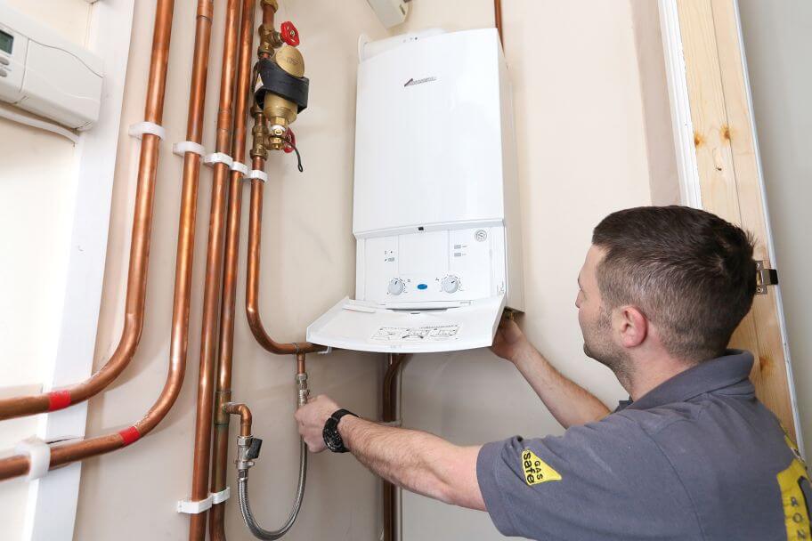Boiler Service - A man working on a domestic boiler