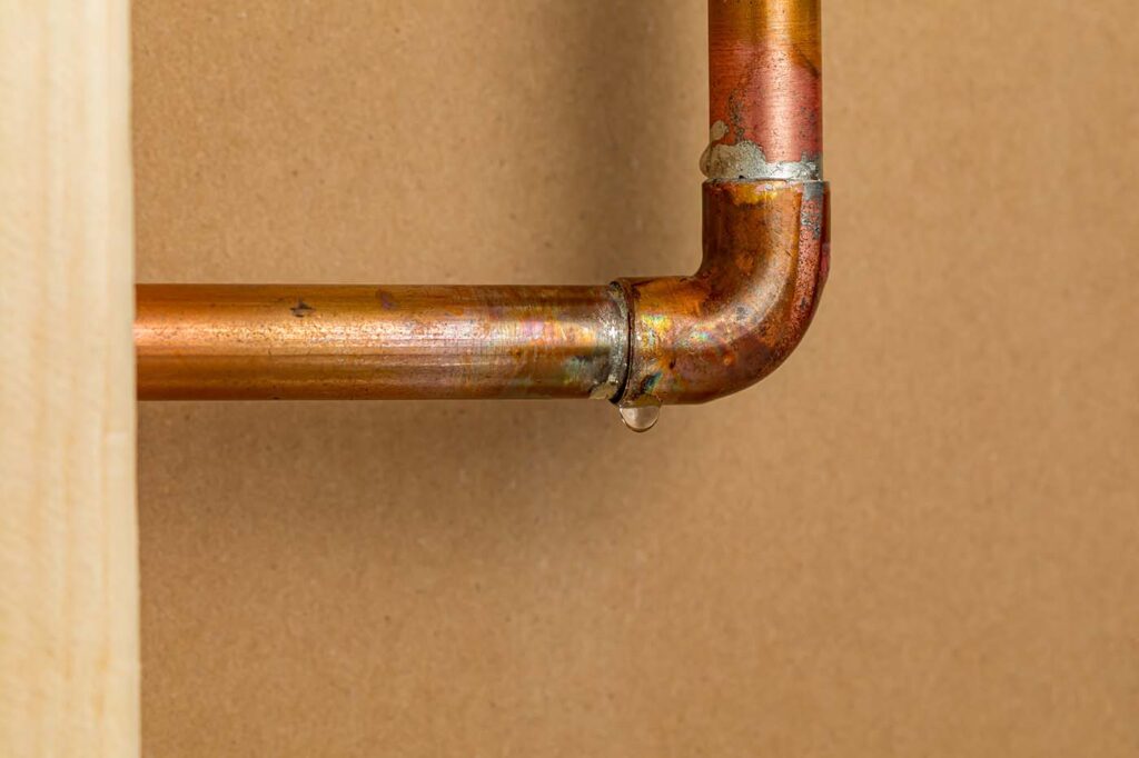Why You Might Have Low Water Pressure - this image shows a water pipe with a slow leak.