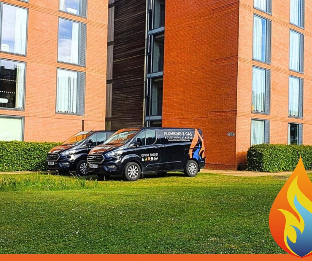 Supporting Cranfield University with Reliable Heating & Plumbing Solutions this image shows two of our vans at Cranfield student accomodation