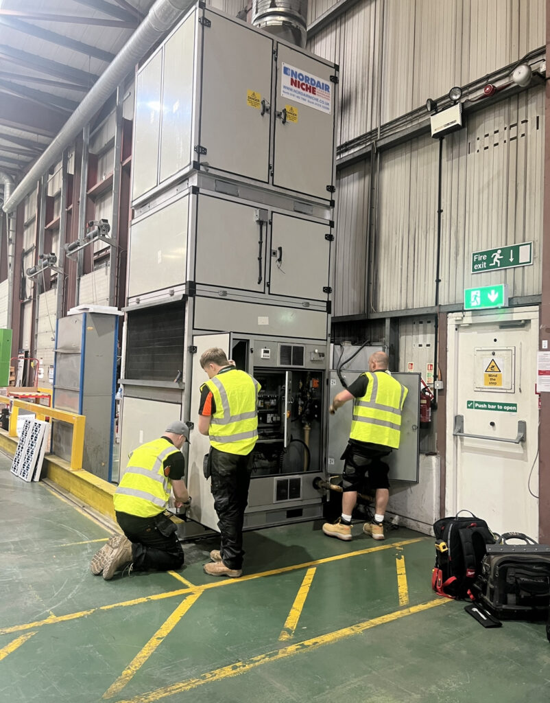 This image shows our engineers installing the warm air heater