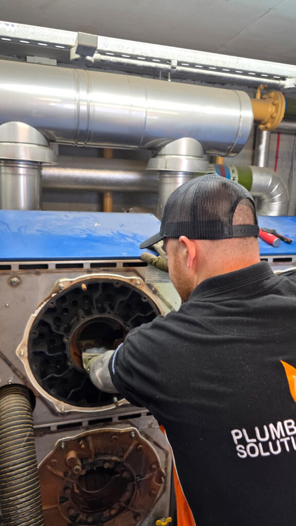Breathing New Life into a Care Home Heating System this image shows Kellan working on pipework