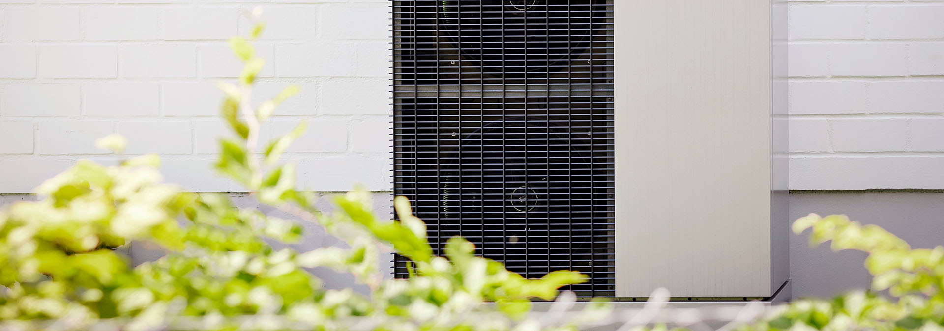 Commercial air source heat pump unit providing low-carbon heating for a building