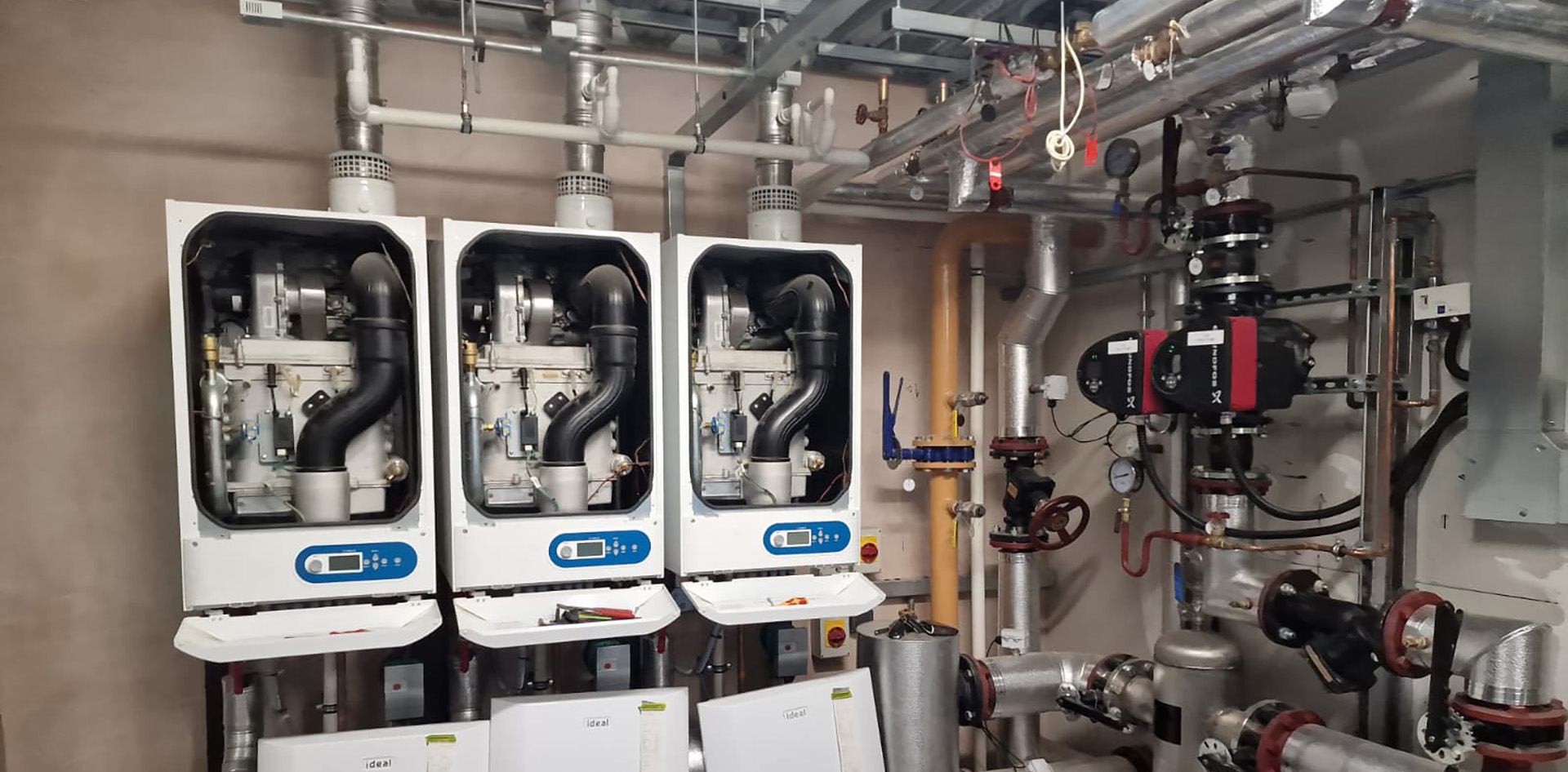 Commercial boiler cascade system installed in a plant room supporting Facilities Management building heating systems. Keeping Facilities Flowing