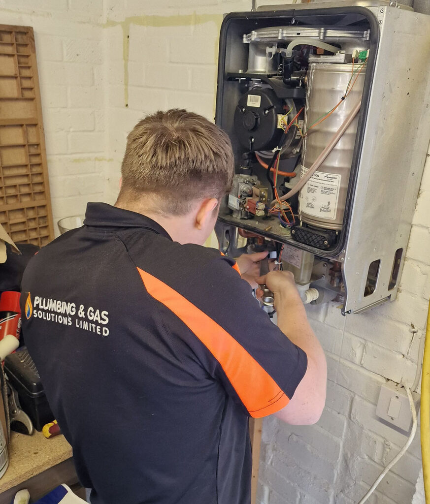 Gas Safe engineer repairing a domestic boiler in Milton Keynes home
