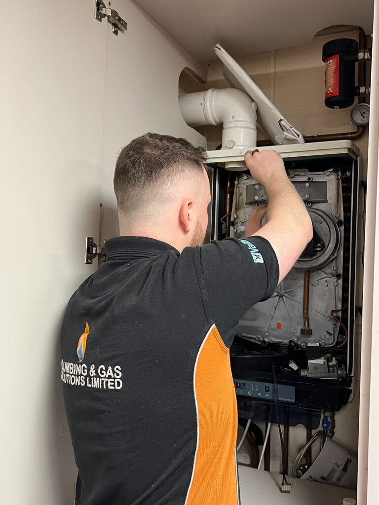 Gas Safe engineer carrying out boiler servicing in Milton Keynes home