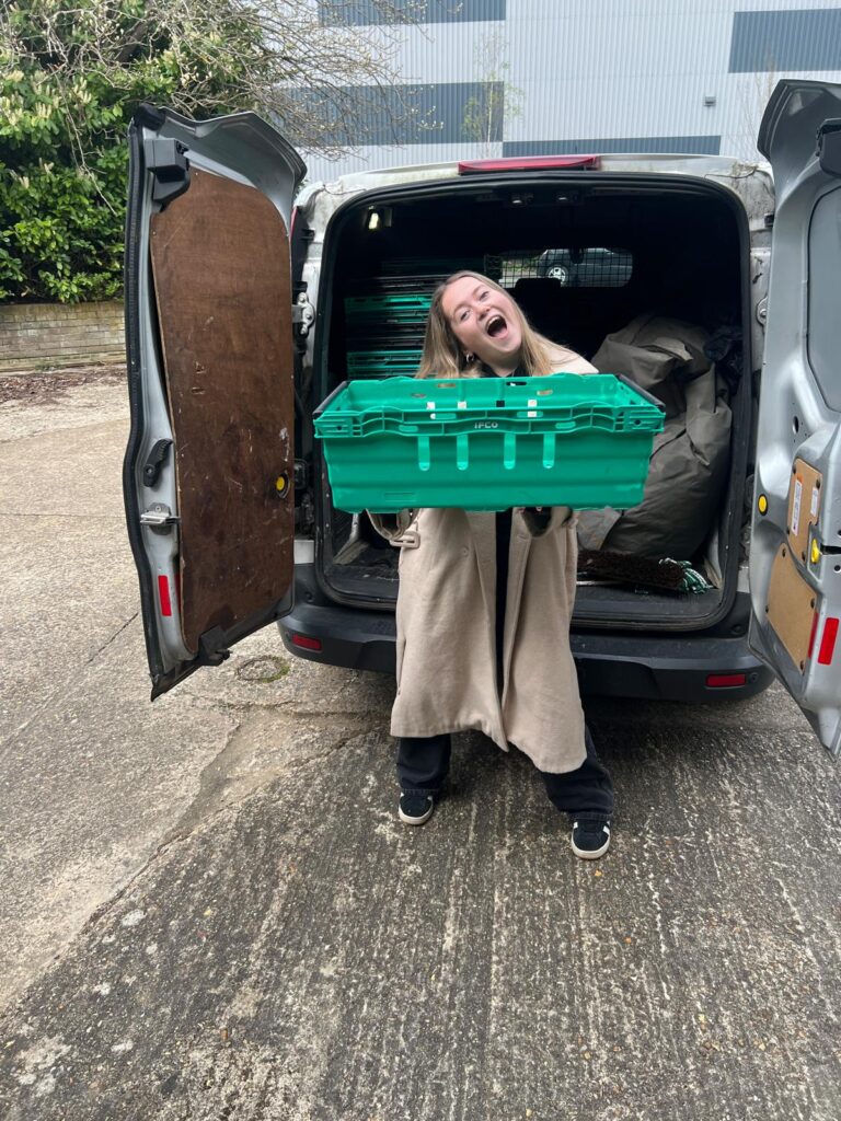Lolah from Plumbing and Gas Solutions collecting MK Food Bank crates for workplace distribution in Milton Keynes