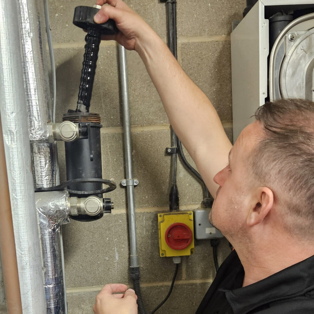 Hugh performing a magnetic filter maintenance job