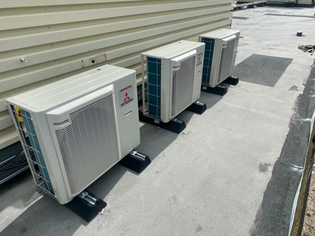 Multiple commercial air conditioning condenser units on a rooftop