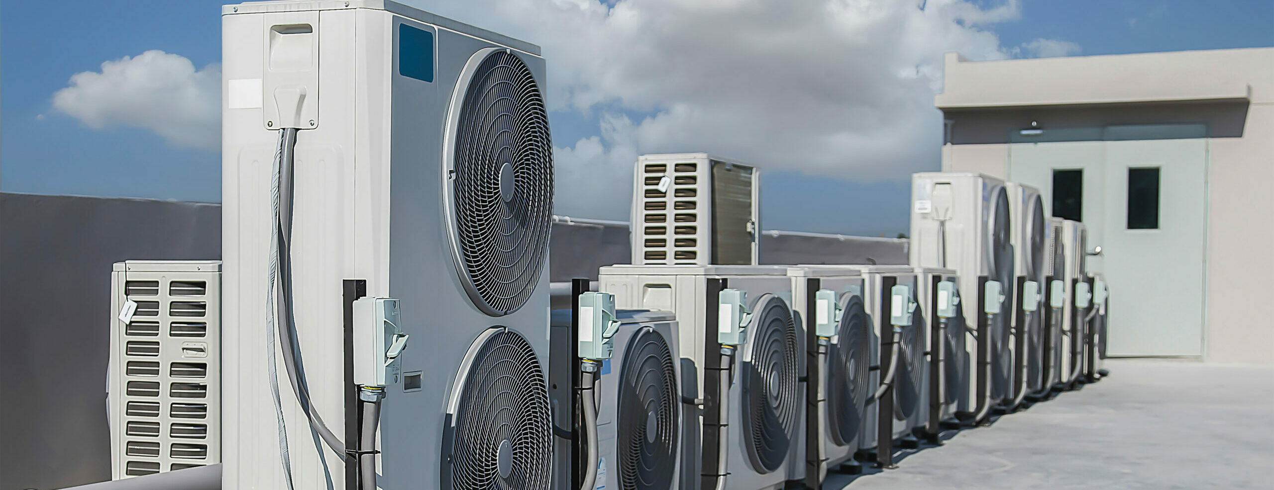 Multiple commercial air conditioning units installed on a rooftop