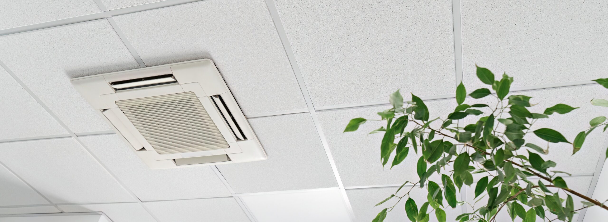 Commercial ceiling-mounted air conditioning unit in a modern office
