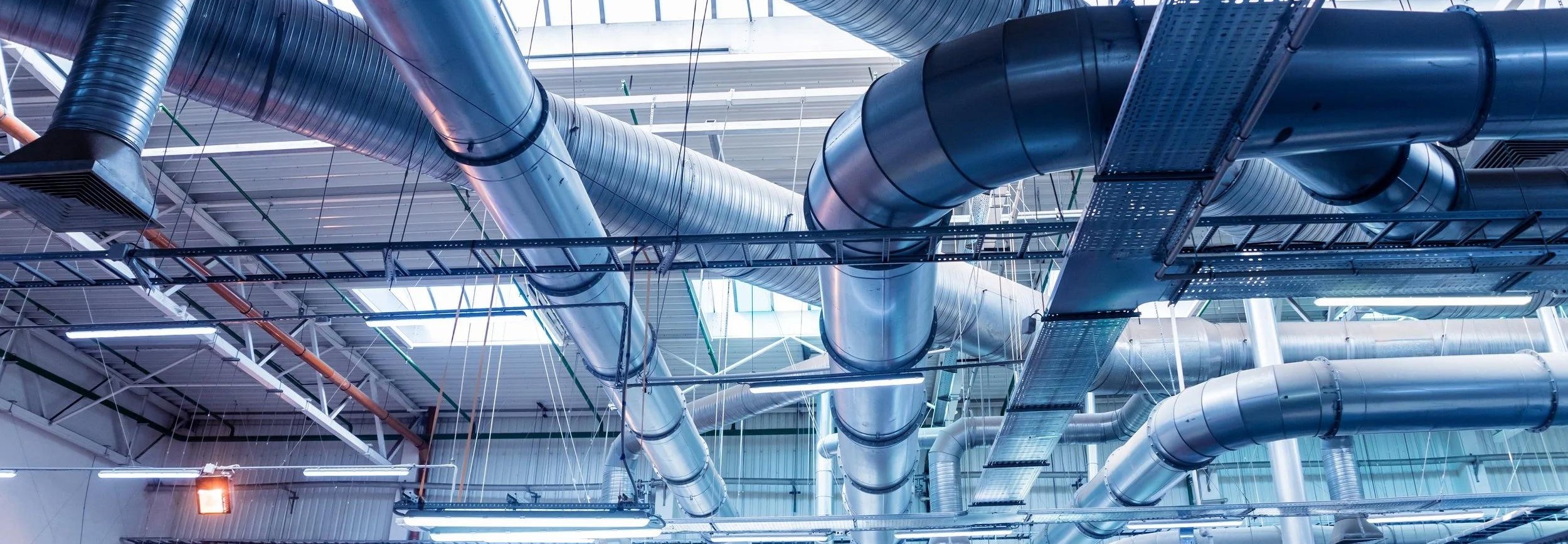 Exposed ventilation ductwork and cable trays in a commercial building
