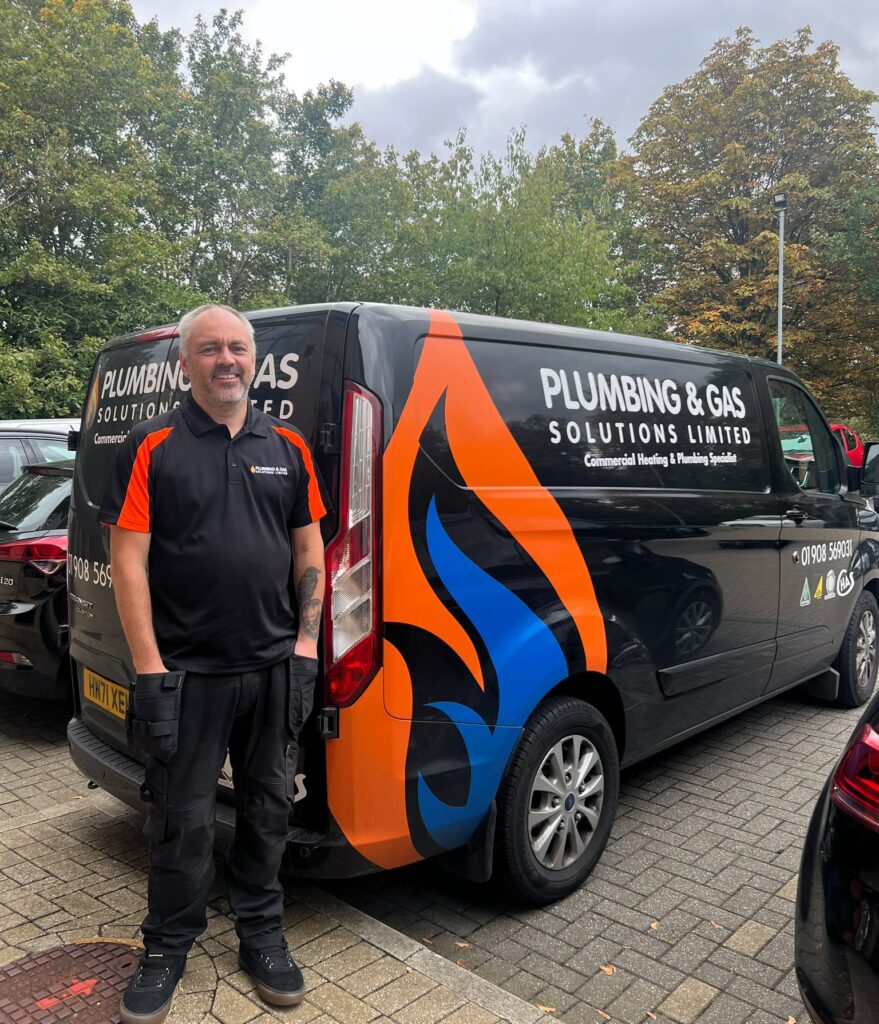 Our HVAC engineer rob standing next to a plumbing and gas van